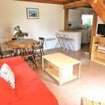 Gite Poppy lounge dining area with sofa, tv, table and chairs