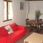 Gite Poppy in Normandy, France. Sitting Room with sofa, coffee table and dining table